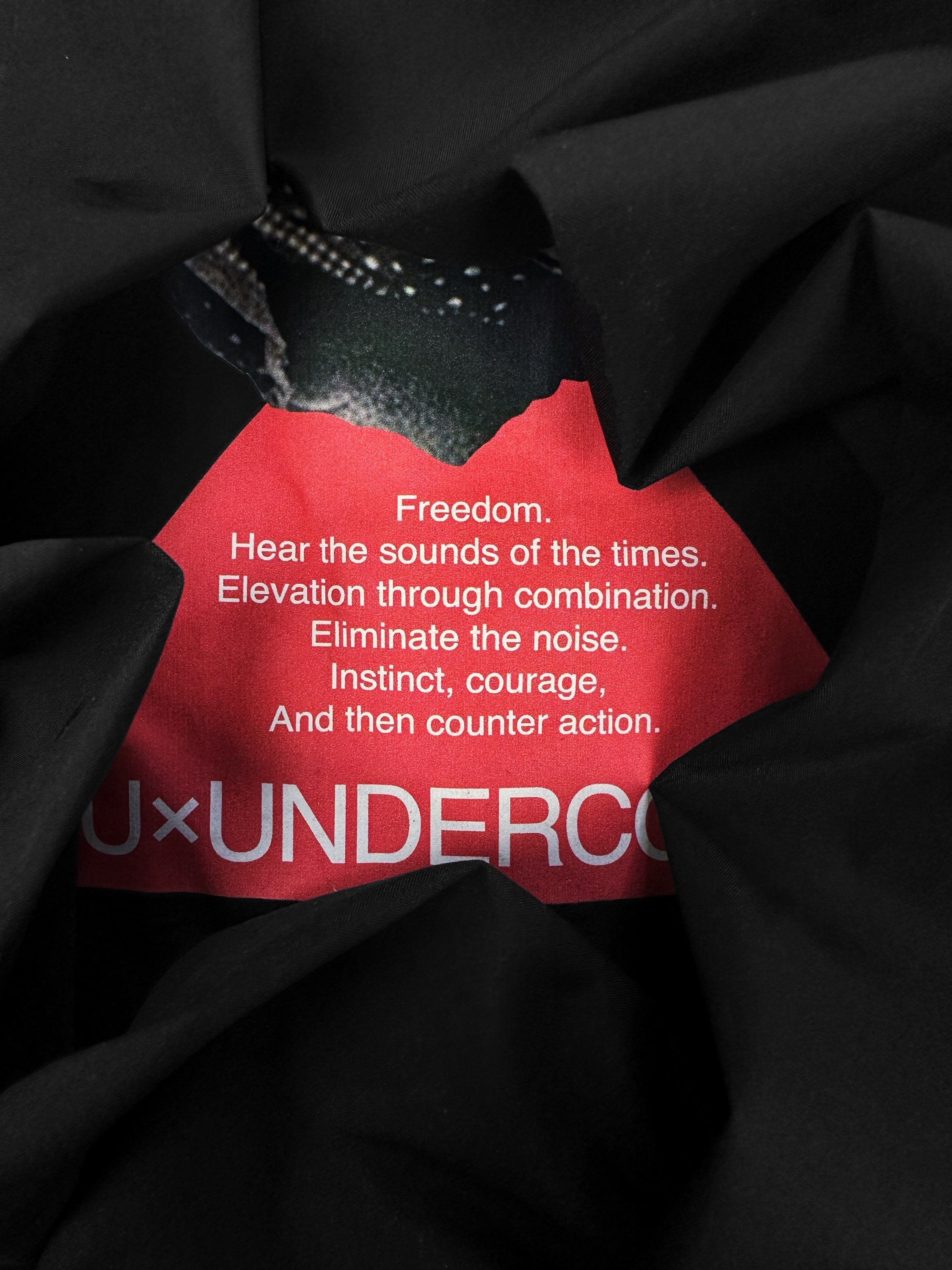 Undercover ‘Face’ Motif Black Windbreaker Jacket