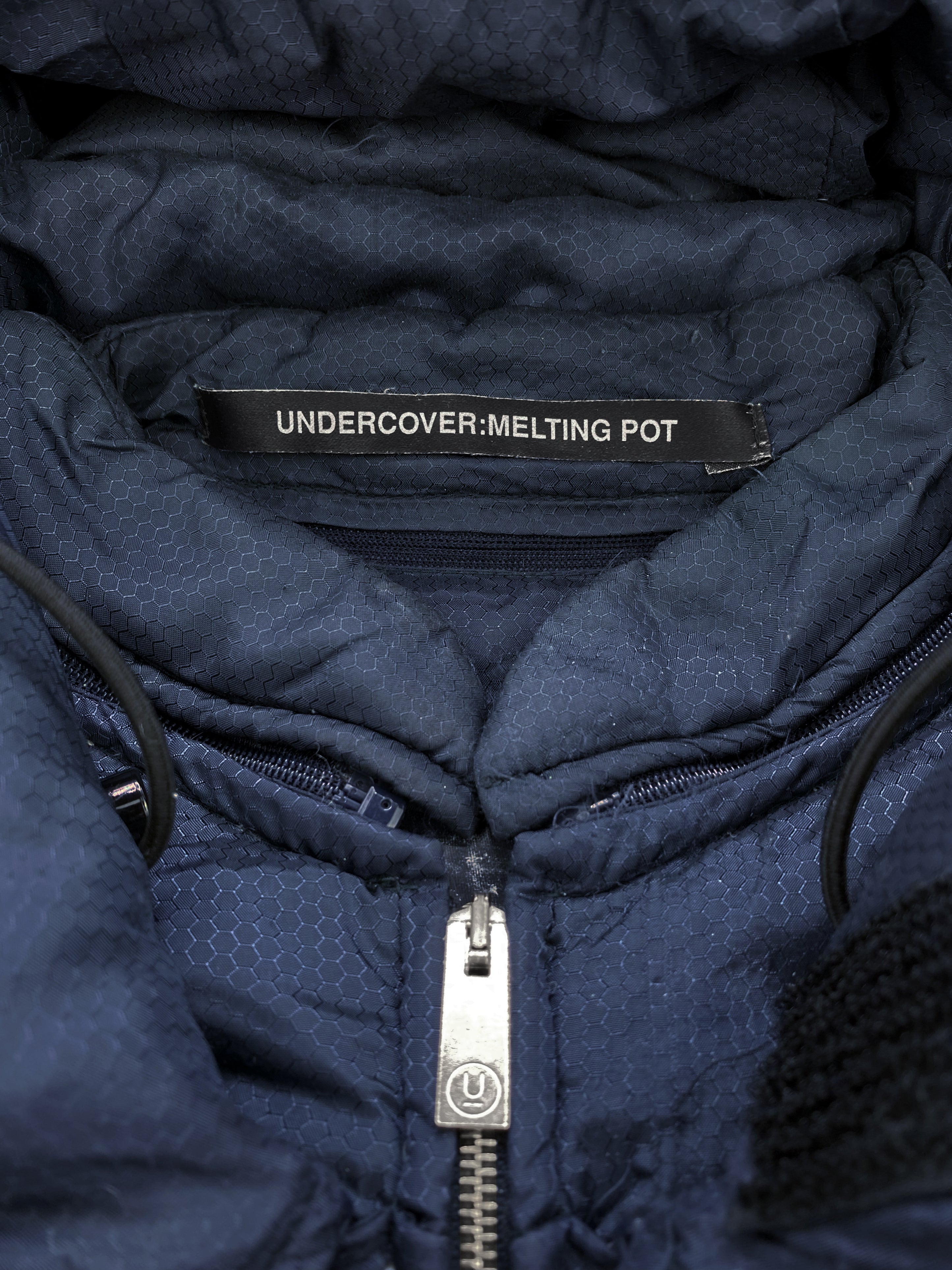 AW01 Undercover “Melting Pot” Small Parts Geometric Puffer Jacket